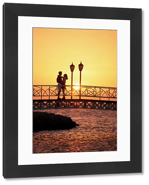 Couple on bridge at sunset, Aruba, West Indies, Dutch Caribbean, Central America