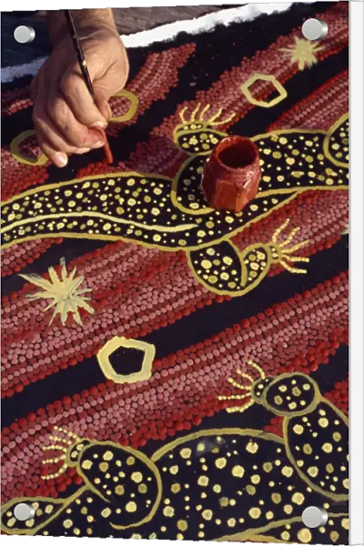 Artist of the Walpiri tribe using a stick to make dream paintings, in Australia, Pacific