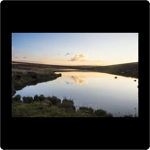 Clouds reflecting in a little lake at sunset, Nyika National Park, Malawi, Africa