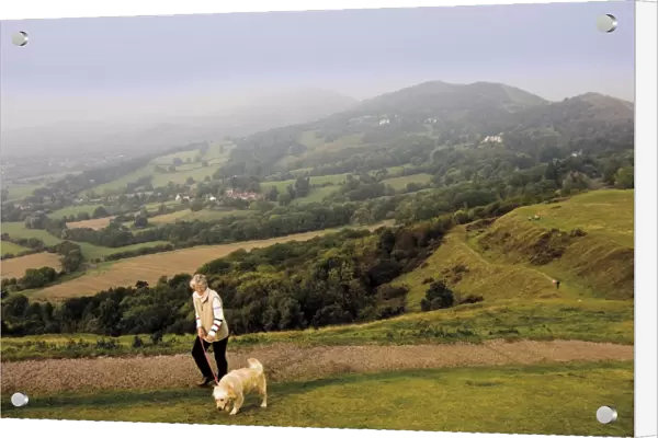 Woman taking dog for a walk, British Camp, Hereford Beacon, Malvern Hills
