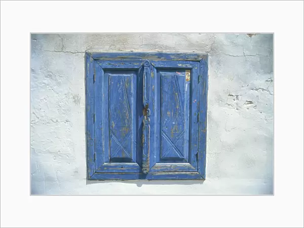 Blue window shutters and white walls