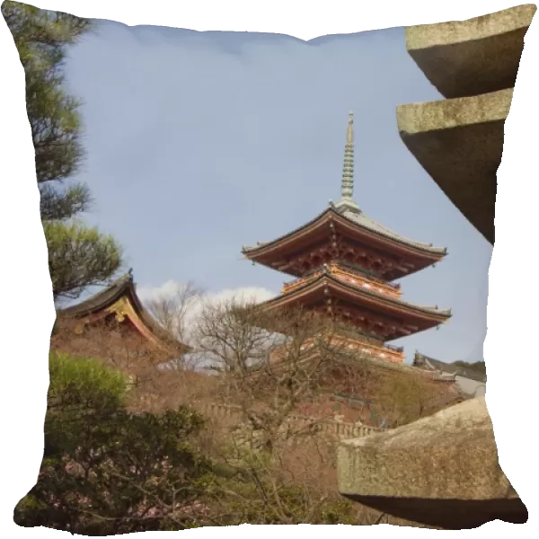 Red pagoda and stone lantern with image of Buddha