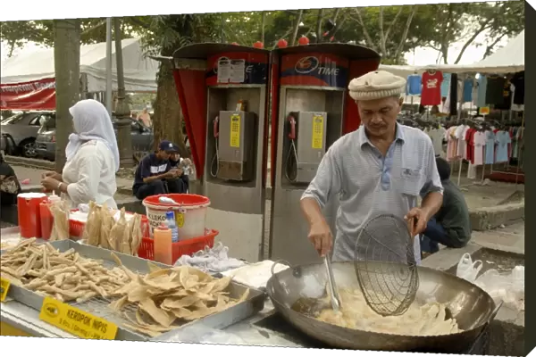 Food vendor frying food outside Central Market