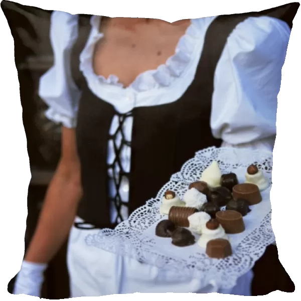 Waitress carrying tray of chocolate