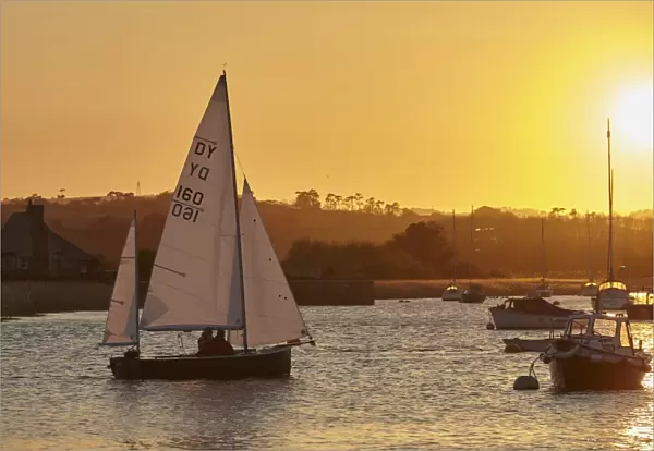A sunset view of sailing on the River Exe at Topsham, near Exeter, Devon, England