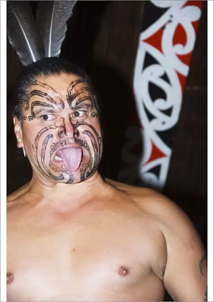 Local Maori man with traditional Moko face tattoo painting