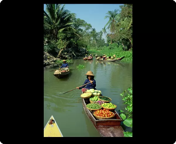 Women in canoes on way to floating market