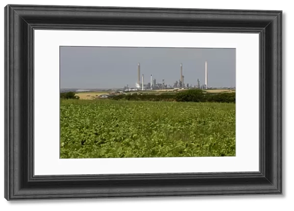 Agricultural land in the foreground and oil refinery