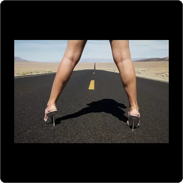 Woman in high heels on empty road