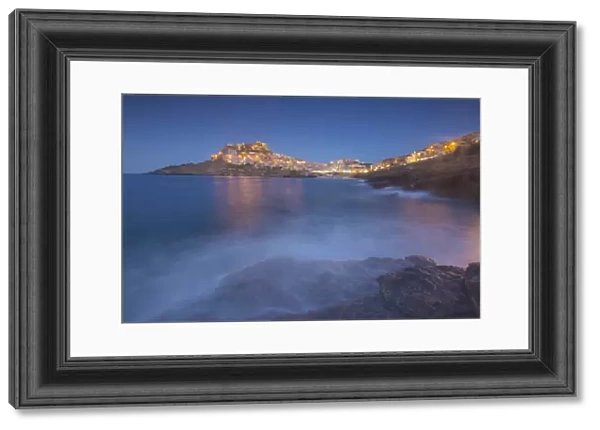 Waves frame the village perched on promontory at dusk, Castelsardo, Gulf of Asinara