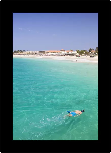 Boy snorkelling off the sandy beach in Santa Maria, Praia de Santa Maria, Baia de Santa Maria
