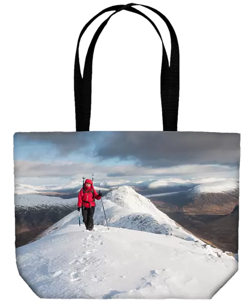A female walker approaching the summit of Stob Dubh on Buchaille Etive Beag on a