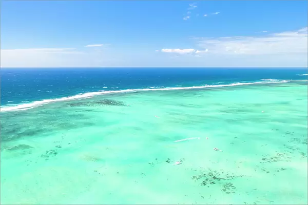 Turquoise coral reef meeting the blue Indian Ocean, aerial view by drone, Ile Aux Cerfs