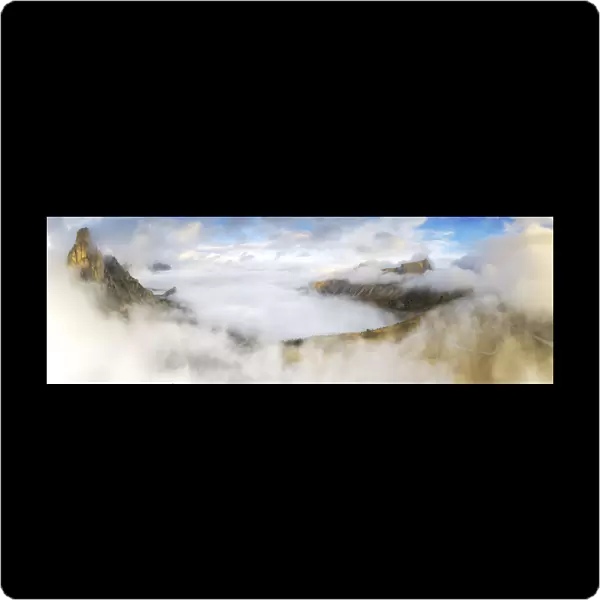 Aerial view by drone of fog over Ra Gusela and Lastoi De Formin in autumn, Giau Pass