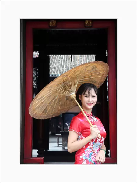 Woman wearing Vietnamese tradition dress called Ao Dai, Taoist temple
