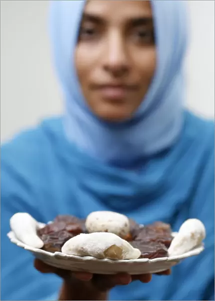Muslim woman offering Ramadan pastries