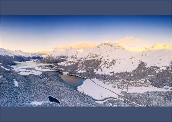 Aerial view by drone of Lej Da Champfer, Silvaplana, snowy Piz Da La Margna