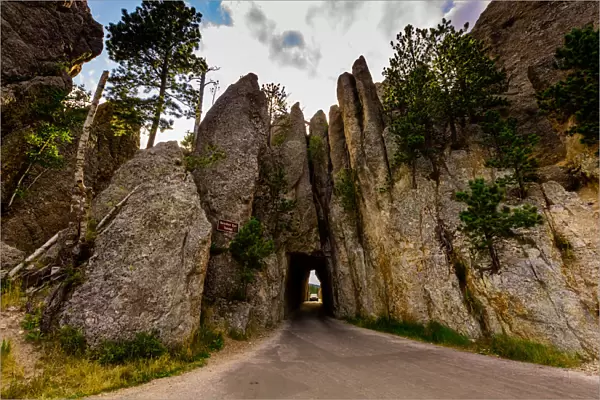 Tiny road passing under a small mountain in the Black Hills of Keystone, South Dakota