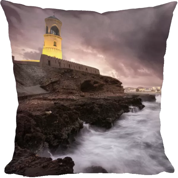 Sur lighthouse with the stormy sea on the cliff and a pink sunset, Sur, Oman, Middle East