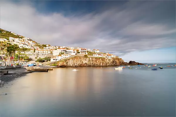 Harbor of the white town Camara de Lobos perched on cliffs, Madeira island, Portugal
