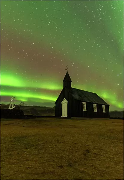 Iconic black wooden Budakirkja church under the Northern Lights (Aurora Borealis), Budir, Snaefellsness Peninsula, Vesturland, Iceland, Polar Regions