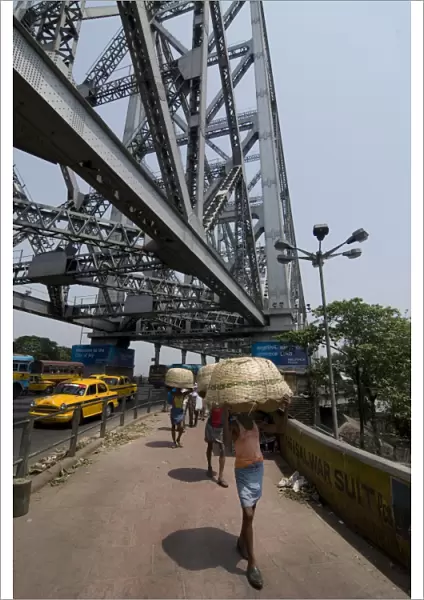 People with baskets on Howrah Bridge, Kolkata, West Bengal, India, Asia