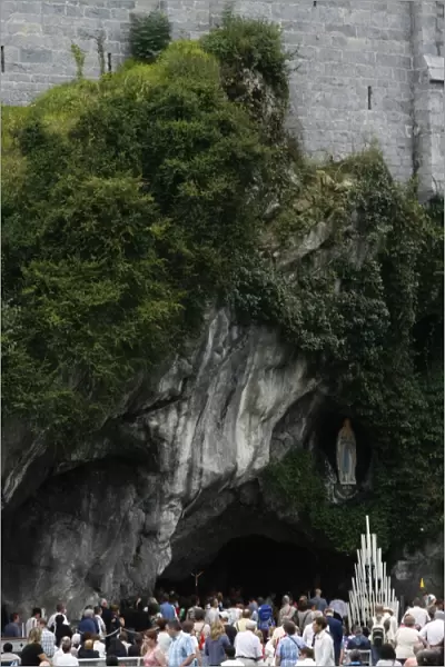 Pilgrims outside the Lourdes grotto, Lourdes, Hautes Pyrenees, France, Europe