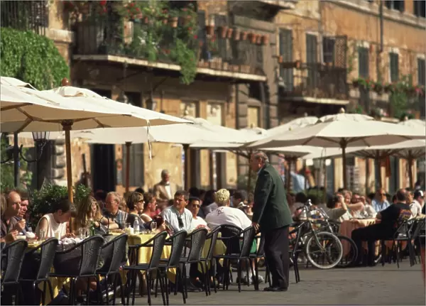 Tourists at a pavement cafe on the Piazza Navona in the city of Rome, Lazio