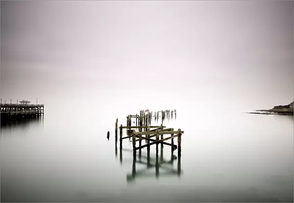 Remains of the old pier on misty morning, Swanage, Dorset, England, United Kingdom