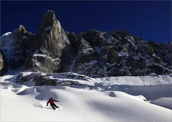 A skier enjoying perfect powder snow on the celebrated Pas de Chevre off-piste run
