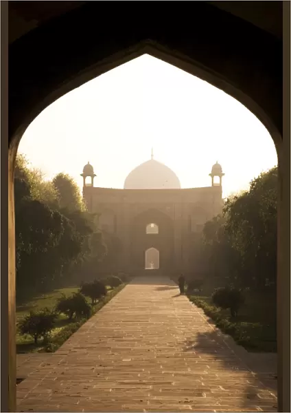 A man takes a morning walk in the Mughal era Humayans Tomb complex