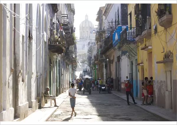View along a typical residential street in Havana Vieja showing children playing