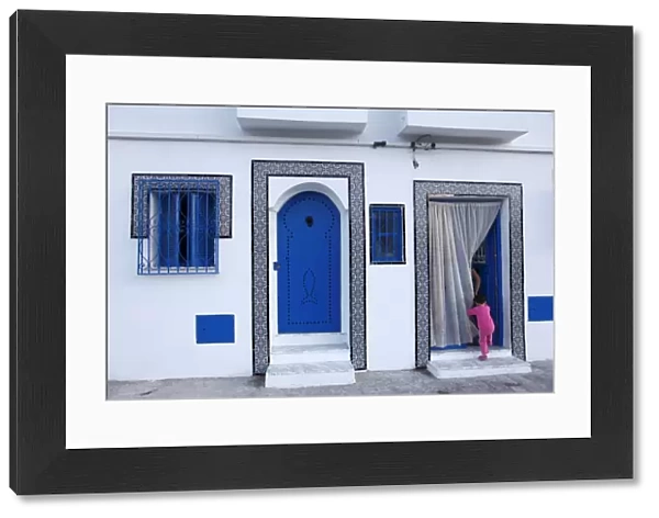Young child and quayside house in the Old Port, Bizerte, Tunisia, North Africa, Africa