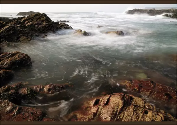 Sea swirling around rocks, near Polzeath, Cornwall, England, United Kingdom, Europe