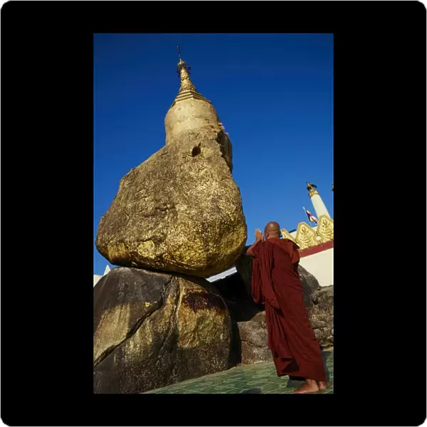 Buddhist monk praying at the Golden Rock of Nwa La Bo, Mawlamyine (Moulmein), Mon State, Myanmar (Burma), Asia