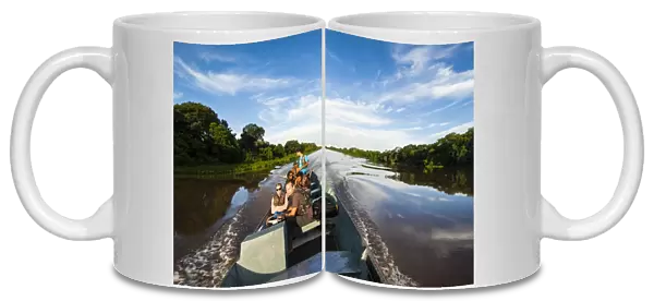 Tourists on a boat searching for animals in the Pantanal, UNESCO World Heritage Site, Brazil, South America