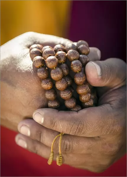 A Buddhist monk holds prayer beads (Japa Mala), Bodhnath, Nepal, Asia