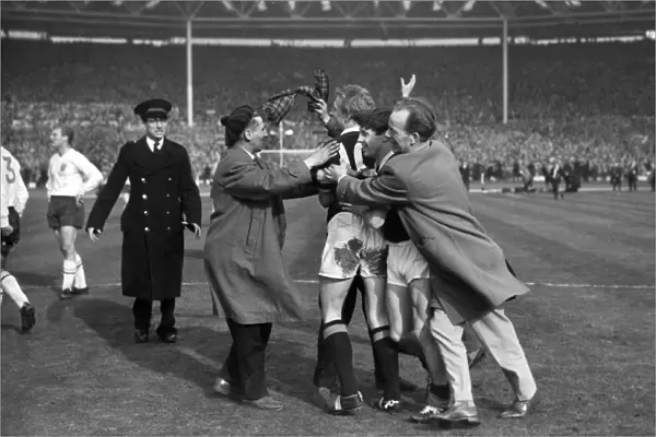 Jubliant fans mob Denis Law and Willie Henderson after Scotlands victory over England in 1963