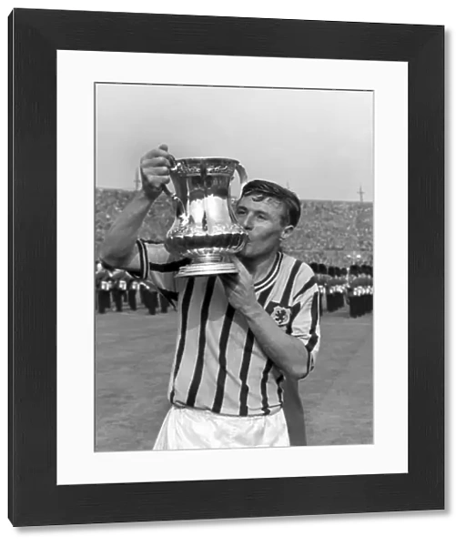 Aston Villa captain Johnny Dixon kisses the FA Cup in 1957