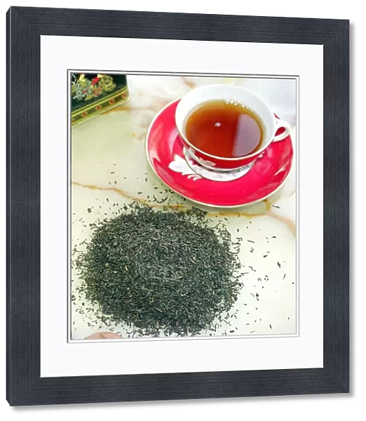 Cup of black tea with tea leaves