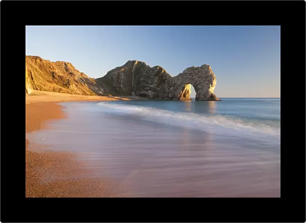 Waves sweeping onto the deserted beach at Durdle Door, Dorset, England. Winter
