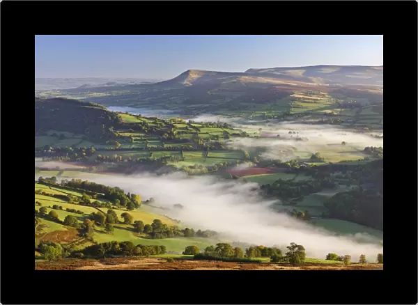 Mist covered rolling countryside backed by the Black Mountains, Brecon Beacons National Park