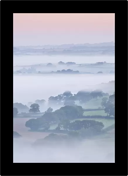Farmhouse and mist covered countryside, Stockleigh Pomeroy, Devon, England. Autumn