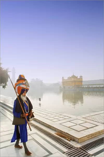 India, Punjab, Amritsar, a sikh pilgrim carrying a barcha spear at the Golden Temple