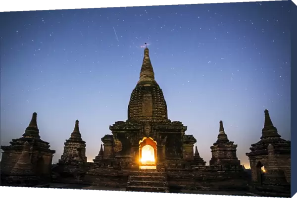 Myanmar, Mandalay division, Bagan. Buddhist pagoda at night under starry sky