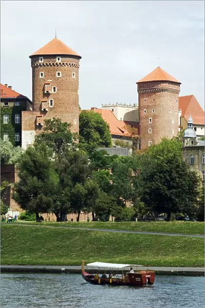 Wawel Hill Castle above Boat on the Vistula River