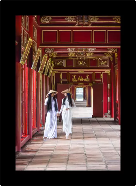 Two young women wearing traditional national costume, ao dai, in the Imperial City