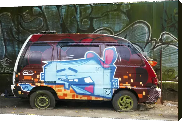 South America, Brazil, Rio de Janeiro, graffiti daubed on the side of an abandoned