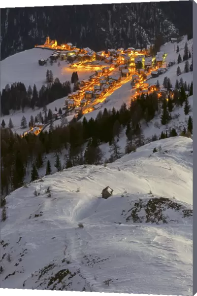The village of Colle Santa Lucia, seen from above on a cold winter evening, Belluno