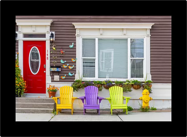Wooden colorful dechchairs in front of traditional house in St Johns downtown